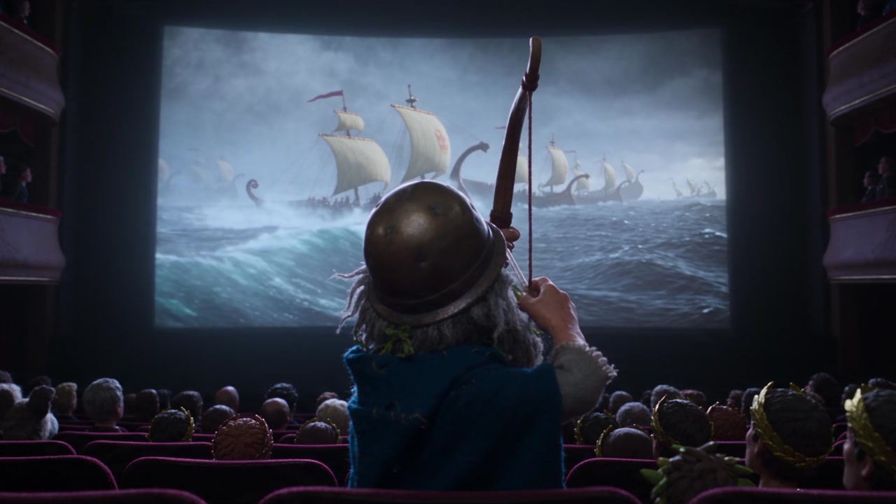 The clay king draws his bow in front of the big screen
