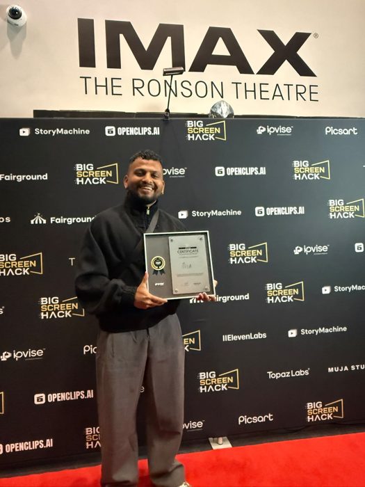 A filmmaker with his certificate on the red carpet