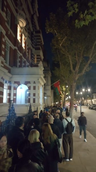 The queue outside the Science Museum at night