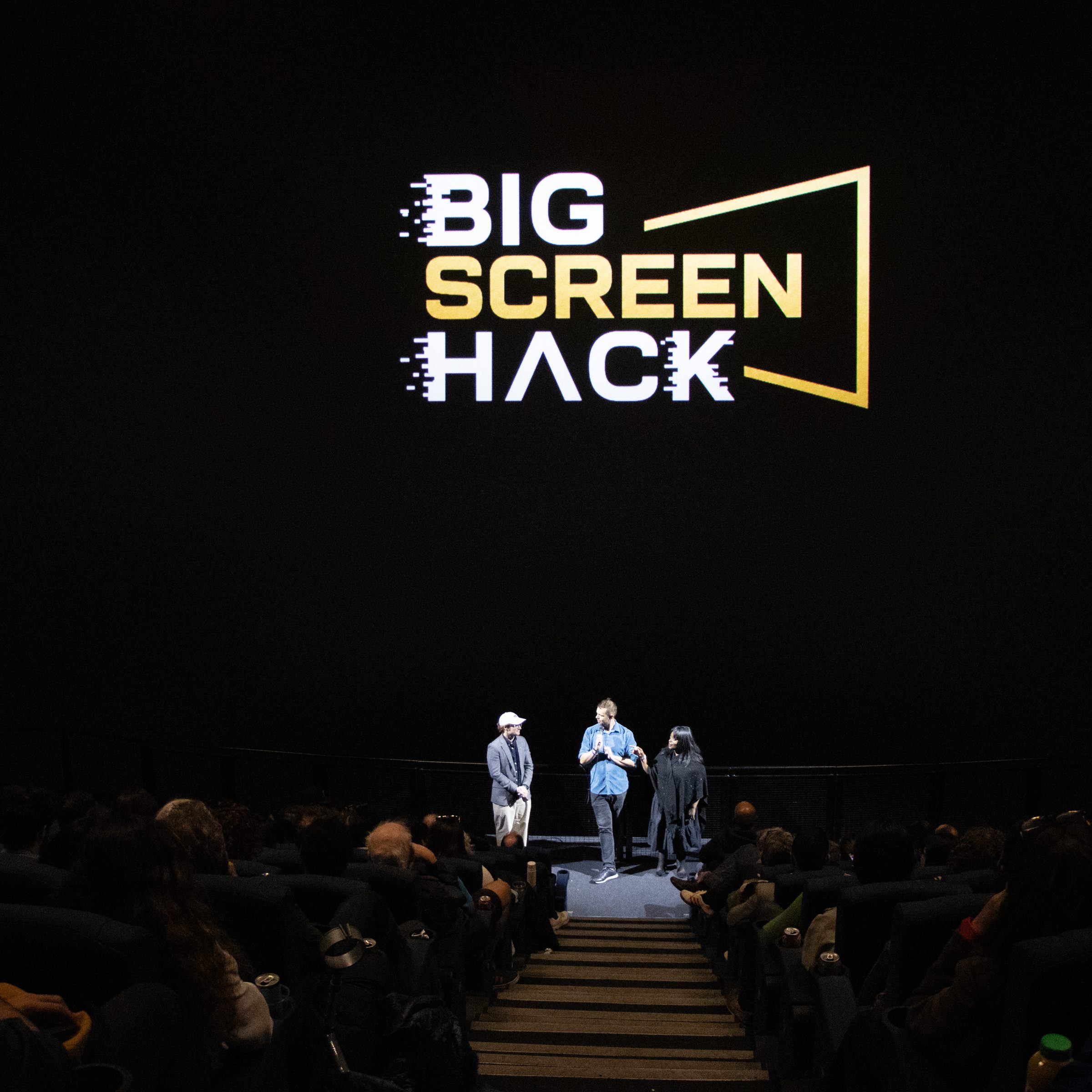 The Big Screen Hack logo on the Science Museum IMAX screen above a full auditorium